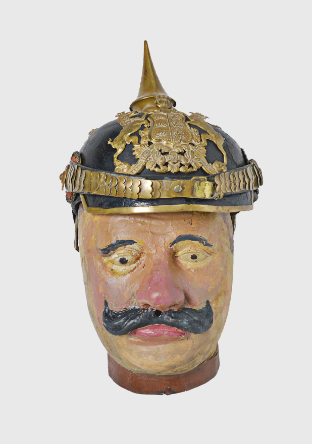 Kopf Züghusjoggeli Einer früherer Kopf des Züghusjoggelis mit Pickelhaube